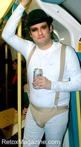 Halloween night: a partygoer in fancy dress takes the London Underground Tube